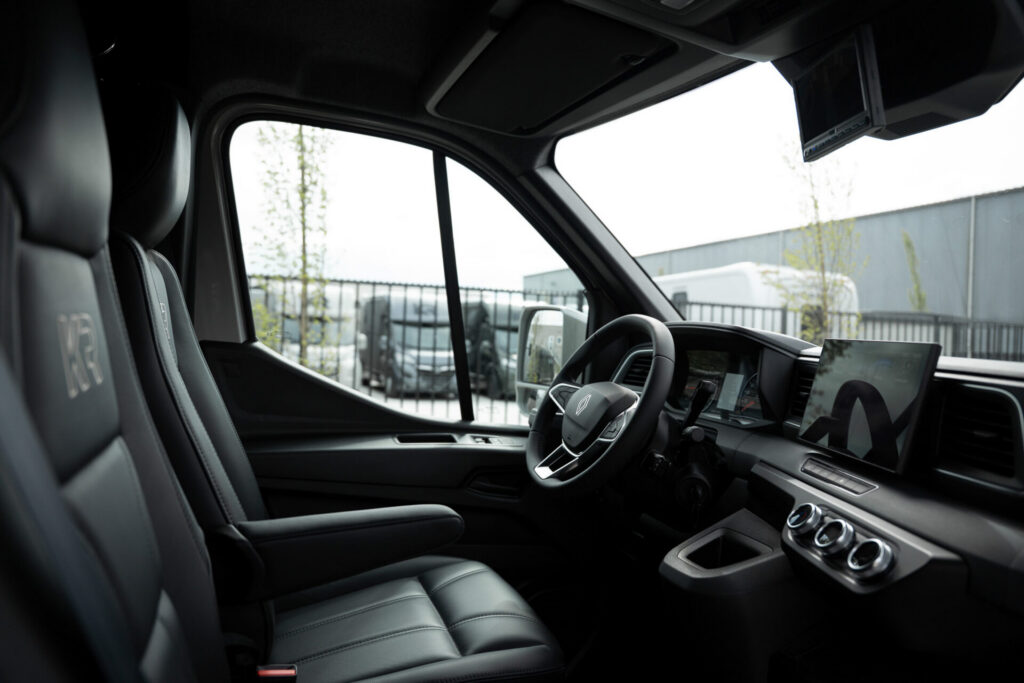 Premium Renault cabin of a Krismar 2-horse truck with three seats, leather upholstery, touchscreen infotainment system and modern interior finish.