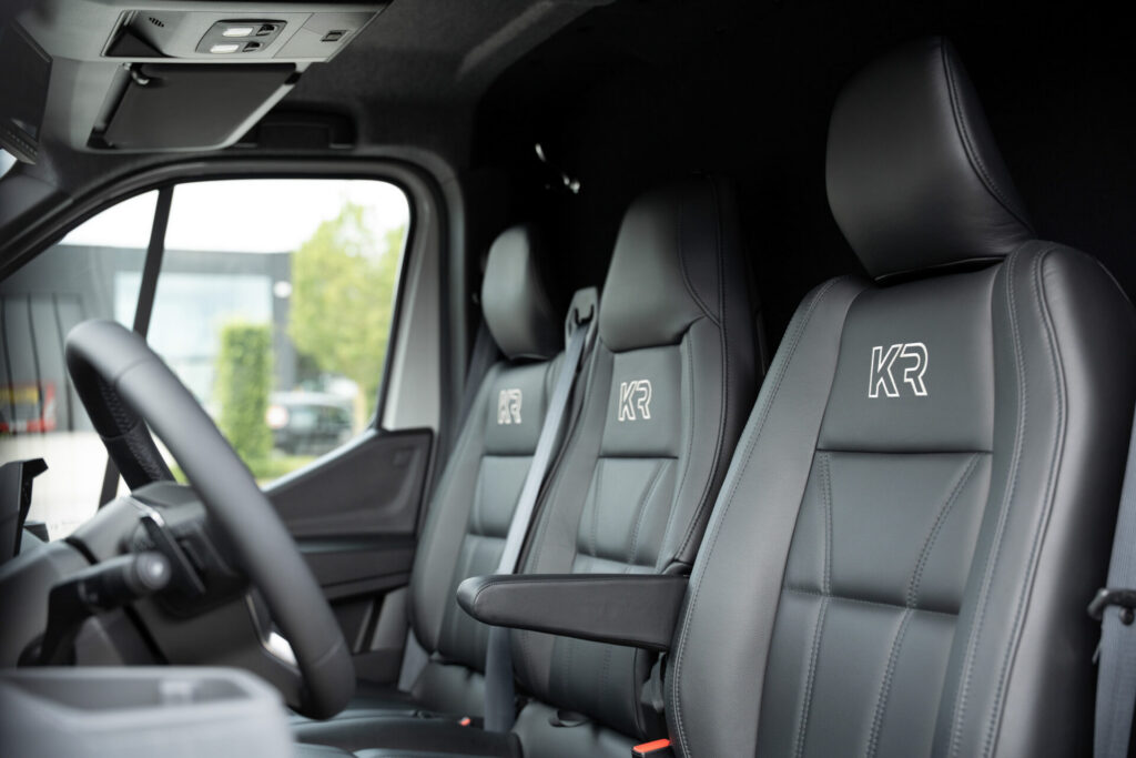 Premium Renault cabin of a Krismar 2-horse truck with three seats, leather upholstery, touchscreen infotainment system and modern interior finish.