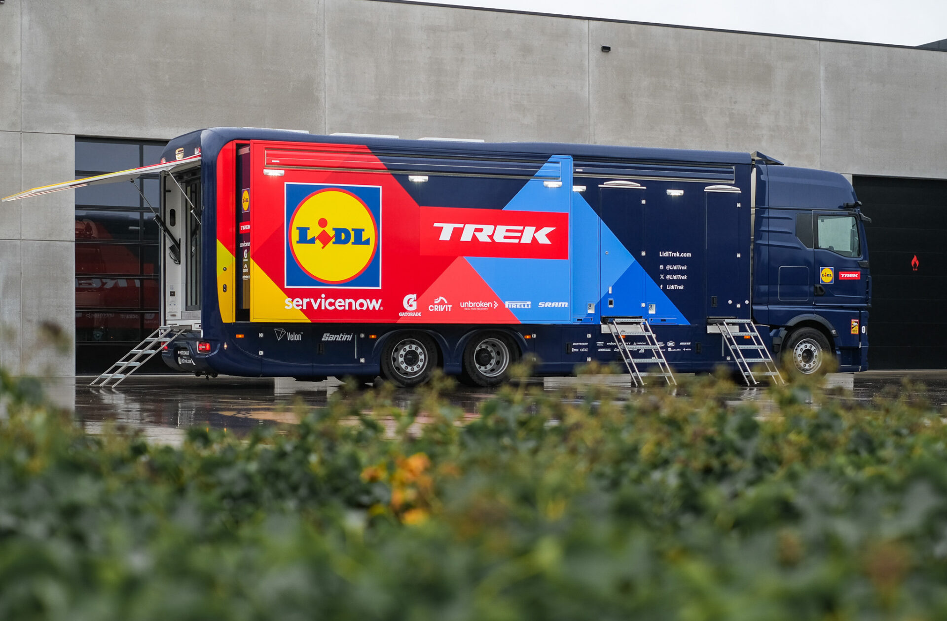 Side view of the custom-built Lidl-Trek mobile workshop by Krismar, providing professional race support and bicycle maintenance facilities.
